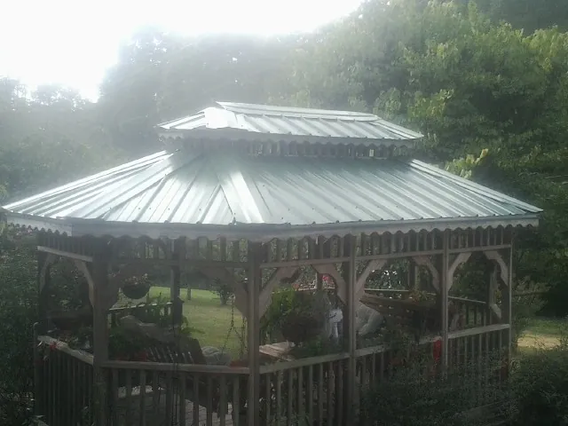 Two tier green metal roof on a garden gazebo in Little Compton